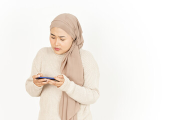 Playing game on smartphone of Beautiful Asian Woman Wearing Hijab Isolated On White Background