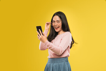 beautiful woman laughing looking at the screen of a smartphone