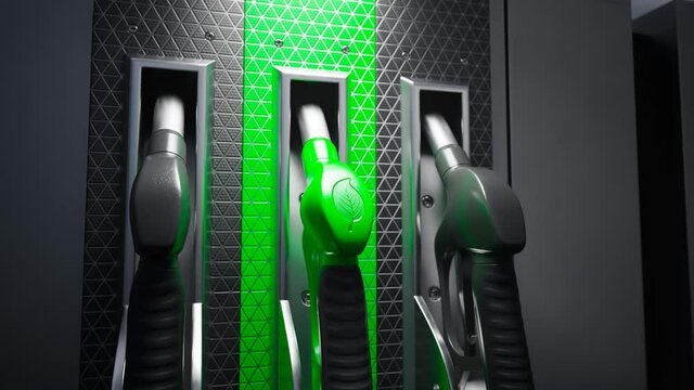 Close up on fuel dispenser. Gas pump nozzle with a green handle and leaf sign.