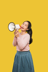 Asian woman screaming while holding megaphone with two hands making announcement