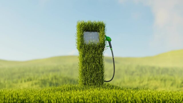 Fuel dispenser with a gas pump nozzle covered by green grass. Eco-friendly fuels