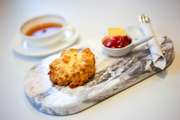 Scone and strawberry jam with black tea.