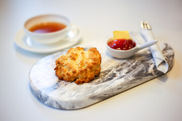 Scone and strawberry jam with black tea.