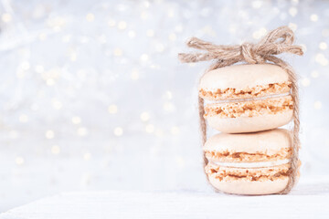 Obraz na płótnie Canvas Sweet Macarons on Christmas Background with Copy Space