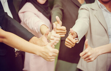 Fototapeta premium Success Teamwork Concepts, Business people with showing thumbs up hands as a team, Group of diverse hands together show thumb up, Young business team in the conference room