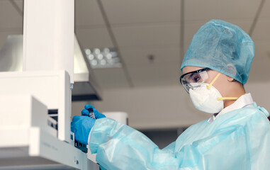 Female scientist looking at the scientific sample in the laboratory