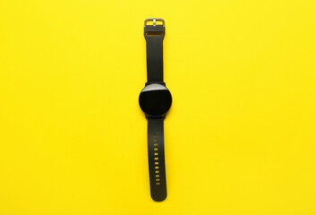 Modern smart watch on yellow background