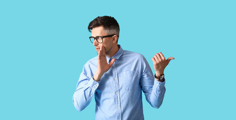 Fototapeta premium Gossiping man on color background