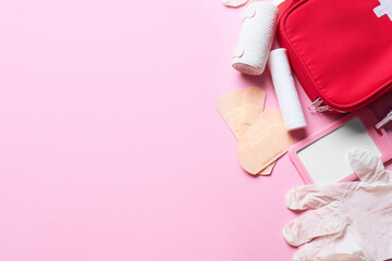 First aid kit and blank identification badge on color background