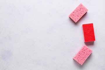Pink cleaning sponges on light background