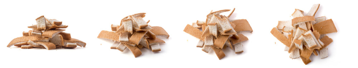 pile of leftover bread crust, use to make bread crumbs, isolated on white background, closeup view in different angles