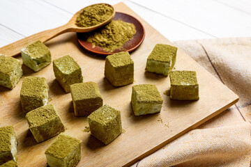 Board with tasty hojicha marshmallows on table, closeup