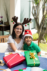 A smiling woman and a toddler with gift boxes