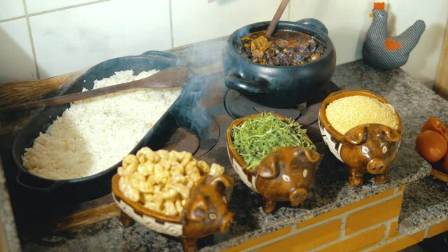 Cooking feijoada on a wood stove