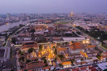 Deurstickers Aerial view Day to Night of Chao Phraya River with Royal Grand Palace and Emerald Buddha Temple Landmark of Bangkok, Thailand. Amazing Drone Footage over the City skyline in twilight. © Sathit Trakunpunlert
