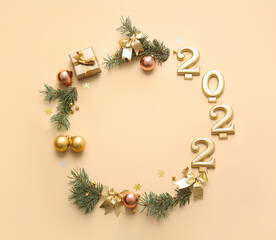Frame made of figure 2022, coniferous branches and decorations on color background