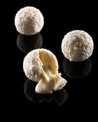 A coconut truffles with filling.