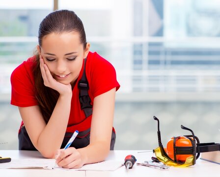 Young woman in coveralls doing repairs
