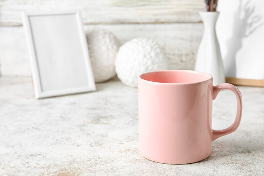 Stylish pink cup on table