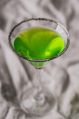 Green martini cocktail for halloween party. Selective focus. Shallow depth of field.