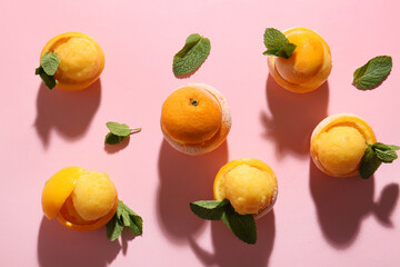 Tasty ice creams in orange peels on color background