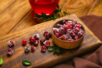 Bowl with tasty sugared cranberries on wooden background