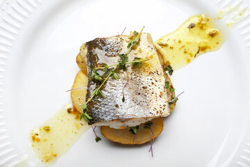 Tasty sea bass fish on plate, closeup - obrazy, fototapety, plakaty