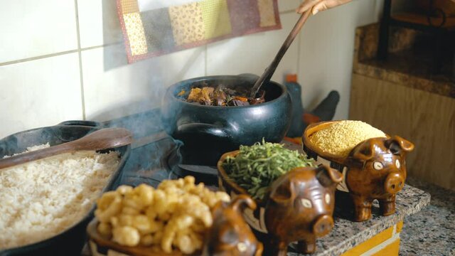 Cooking feijoada on a wood stove