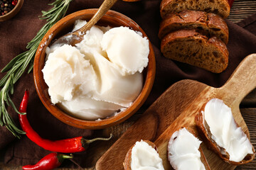 Bowl of lard spread and bread pieces on wooden background