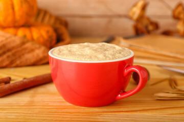 Tasty cup of coffee on wooden background