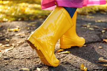 Young woman in gumboots outdoors on autumn day