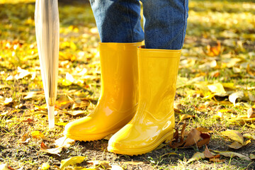 Young woman in gumboots outdoors on autumn day