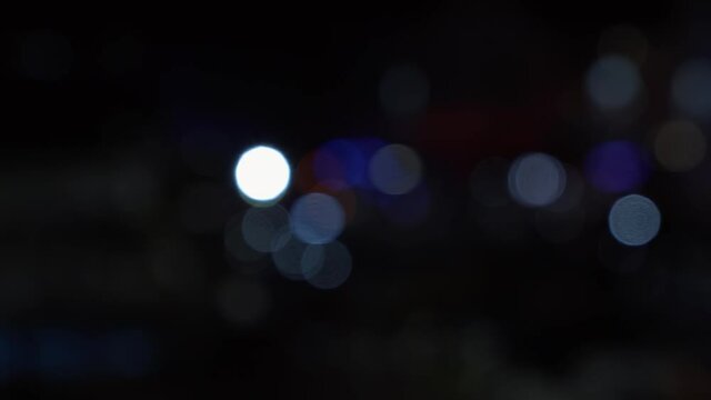 Out of focus shot of bokeh siren lights flashing in the background