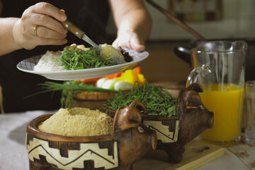 Serving feijoada, a Brazilian dish on a lunch table