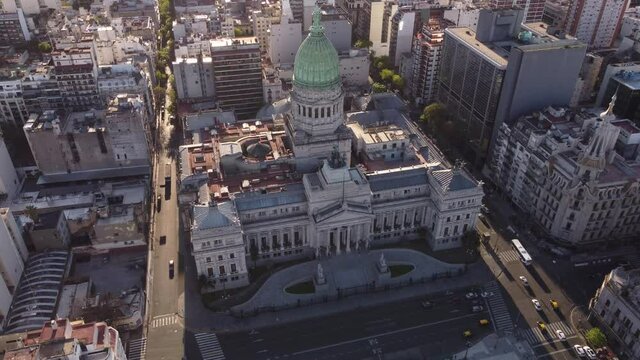 4K Aerial shot of historic old Building of National Palace Congress in Buenos Aires during sunset - Cars driving on narrow road - Tracking shot