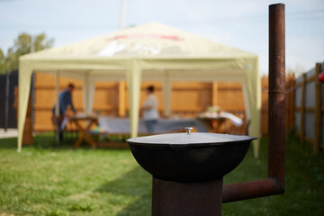 Summer vacation in the backyard cooking delicious pilaf in an outdoor oven