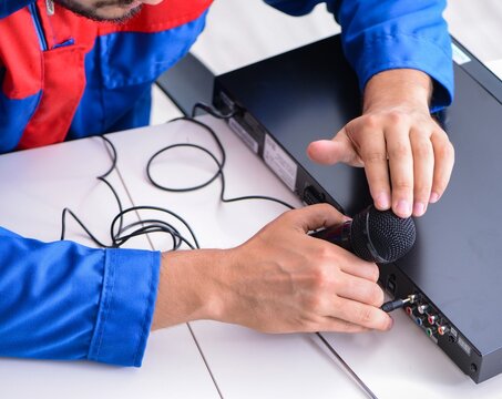 Man repairman repairing dvd player at service center