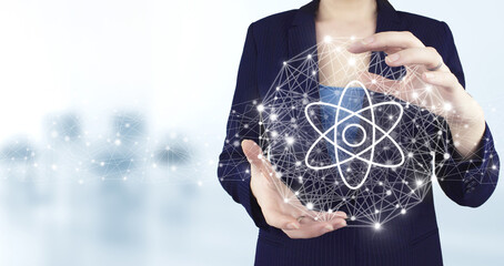 Atom molecule as concept for science. Two hand holding virtual holographic molecule atom icon with...