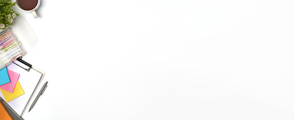 White office desk with clipboard, sticky notes and houseplant.