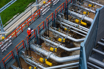 Top view male worker inspection at the valve of visual check record pipeline oil and gas.