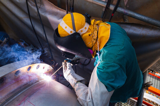 Welding male worker metal is part in machinery nozzle pipeline construction