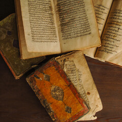 Stack of open ancient books in Arabic. Old Arabic manuscripts and texts. Top view