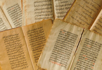 Stack of open ancient books in Arabic. Old Arabic manuscripts and texts. Top view