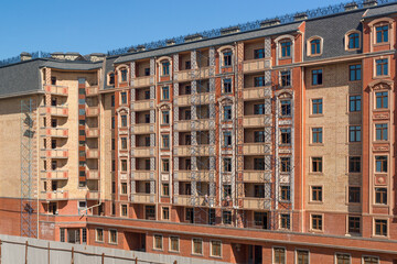 Fototapeta premium Finishing works on the facade of a new residential buildings