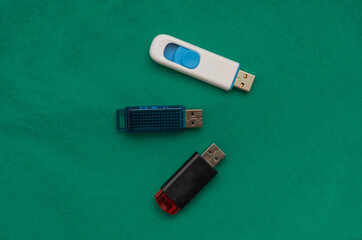 USB flash drives on a green background