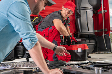 Truck Driver Pointing the Issue to His Mechanic