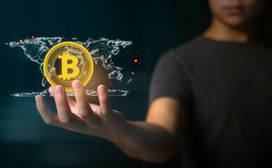Man holding Bitcoin Cryptocurrency Hologram with world map, BTC the blockchain-based currency that can do business and transactions , Concept technology, internet business, investment.