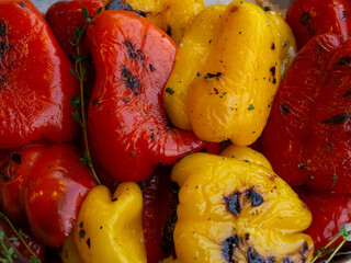 grilled red and yellow peppers. grilled peppers preparation for further cooking. street food