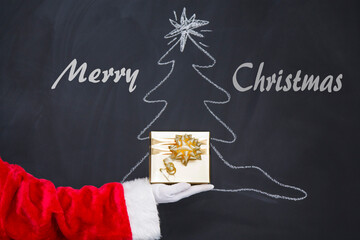 Fototapeta na wymiar Christmas gift from Santa Claus.Christmas holiday background on blackboard