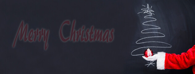 Fototapeta na wymiar santa claus decorating the christmas tree